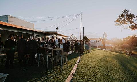 Sunset at Eagle Bay Brewing Co, with patrons enjoying themselves talking, drinking and eating outdoors in the Beer Garden