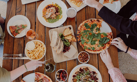 food on a table with people's hands reaching in at a restaurant in Dunsborough