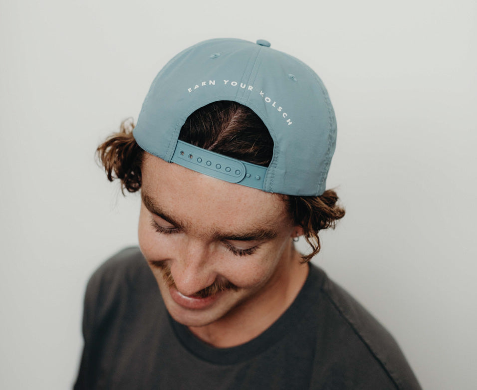 Eagle Bay Brewing Co merch hat that says 'Earn your Kolsch'.