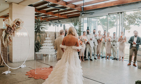 A bride greeting her guests inside at Eagle Bay Brewery's wedding venue