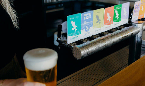 Pouring a ice cold beer off the tap at Eagle Bay Brewing Co