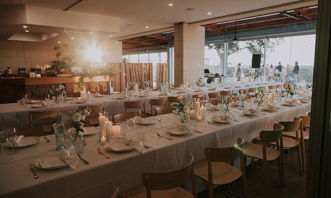 The interior of Eagle Bay Brewing Co's wedding venue decorated for a wedding ceremony and dinner before guests arrive